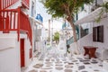 Mykonos town streetview with tree and red banisters, Mykonos town, Greece