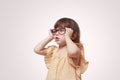 Myopia in children. Portrait of beautiful little girl wearing glasses on grey background. Vision, health, ophthalmology Royalty Free Stock Photo