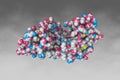 Myotoxin II from Bothrops moojeni co-crystallized with Varespladib. Space-filling molecular model on grey background Royalty Free Stock Photo