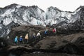 MYRDALSJOKULL, ICELAND - AUGUST 2018: Group of tourists heading to the guided tour on Solheimajokull glacier, Iceland