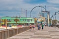 Myrtle Beach, South Carolina - April 4, 2018: Promenade along the beach and city buildings on a sunny spring day Royalty Free Stock Photo