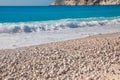 Myrtos beach with white pebbles and azure water against blue sky - Kefalonia island, Ionian sea, Greece. Royalty Free Stock Photo