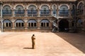 Mysore, India - December 10 2017: Yard in Mysore Palace with windows and arches with female security Royalty Free Stock Photo