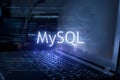 MySQL inscription against laptop and code background. Learn sql programming language, computer courses, training Royalty Free Stock Photo