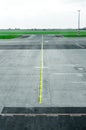 Myst on empty airport runway tarmac with directional and markings sign Royalty Free Stock Photo