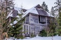 Mysterious abandoned wooden house in a spruce forest Royalty Free Stock Photo