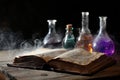 Mysterious Ancient Book and Potion Vials on Rustic Wooden Table. Royalty Free Stock Photo