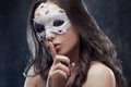 Mysterious and beautiful brunette with Venetian mask.