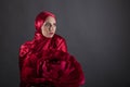 Beautiful woman in the red silk dress of the Eastern Muslim peoples Royalty Free Stock Photo