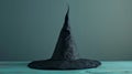 Mysterious black witch hat on a wooden table