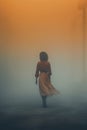 mysterious black woman wearing a long orange dress. foggy gradient background.