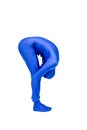 Mysterious blue man in costume doing yoga