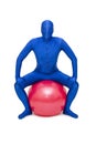 Mysterious blue man in morphsuit exercise with pilates ball