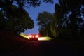 A mysterious car, parked on a country road on a summers night in a woodland Royalty Free Stock Photo