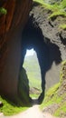 Mysterious Cave Entrance Leading into the Heart of the Mountain Royalty Free Stock Photo