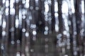 Mysterious Christmas silver defocused background. Silver festive texture with twinkling bokeh stars. Abstract blurred