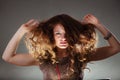 Mysterious enigmatic woman girl with flying hair. Royalty Free Stock Photo