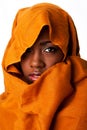 Mysterious female face in ocher head wrap Royalty Free Stock Photo