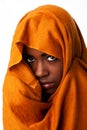 Mysterious female face in ocher head wrap Royalty Free Stock Photo