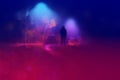 A mysterious figure standing in the middle of a road with street lights on a misty winters night. With a blurred, neon, out of Royalty Free Stock Photo