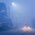 mysterious fog on the street in a small town at night Royalty Free Stock Photo