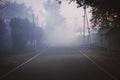 mysterious fog on the street in a small town at night Royalty Free Stock Photo