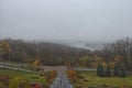 Mysterious foggy autumn morning. Panorama of Kyiv from the Park of Fame Park of Glory