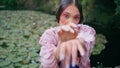 Mysterious girl posing camera waving hands on park pond close up. Majestic woman Royalty Free Stock Photo