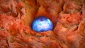 Mysterious glowing blue sphere on rocky ground 3D render