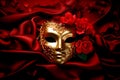 Mysterious golden Venetian mask and red roses flowers on red silk background