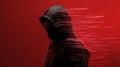 Mysterious hacker wearing black hoodie and mask creating code on red background Royalty Free Stock Photo