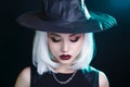 Mysterious Halloween witch woman portrait on black background