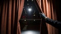 Mysterious hand peeking behind curtain at theater dramatic setting stage environment intriguing ideas Royalty Free Stock Photo