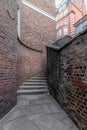 A mysterious and hidden old back alley with staircase in London at night Royalty Free Stock Photo