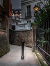 A mysterious and hidden old back alley with staircase in London at night Royalty Free Stock Photo