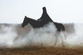 A mysterious horseman on a horse walks through the thick smoke