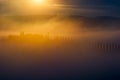 Mysterious house with row of cypress trees in early morning golden sun Royalty Free Stock Photo