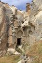 The inconspicuous entrance to the old ancient cave temple in the mountain valley of Cappadocia Royalty Free Stock Photo