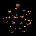 Mysterious juggling man in dark. Ten hands concept. Royalty Free Stock Photo