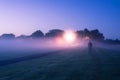 A mysterious lone ghostly, figure standing in a field just befor