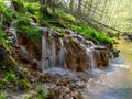 Spring river waterfall,  stones, green moss and spring trees, David`s sources, Latvia Royalty Free Stock Photo