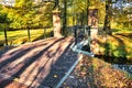 Mysterious long shadows and gates to historic mansion