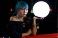 Mysterious magnificent beautiful woman fortune teller in black dress holding a luminous crystal ball, dark witch with magical ball Royalty Free Stock Photo