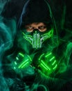 Mysterious man in black wear, neon mask and gloves. Character pastor or wizard in robe from the future. Assassin with