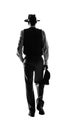 mysterious man walking away and holding a briefcase. noir concept of a private detective walking away. Isolated transparent PNG. Royalty Free Stock Photo