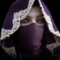 Mysterious masked hooded female staring at the camera