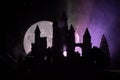 Mysterious medieval castle in a misty full moon. Abandoned gothic style old castle at night Royalty Free Stock Photo
