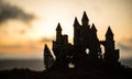 Mysterious medieval castle at sunset. Abandoned gothic style old castle at the evening