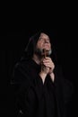 mysterious medieval priest with wooden cross