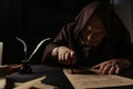 mysterious monk in hood stamping manuscript Royalty Free Stock Photo